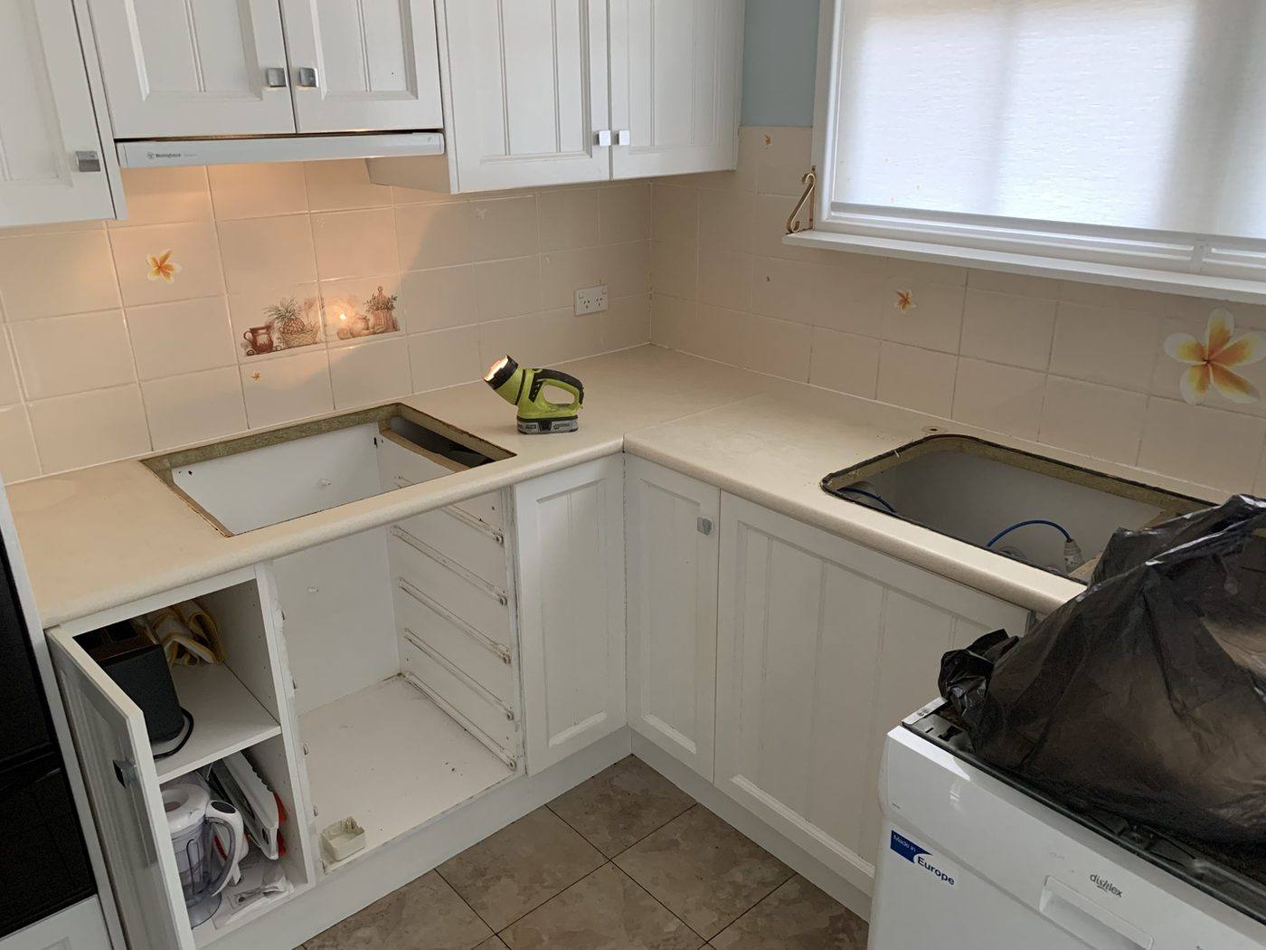 Original tile splashback and laminate benchtop being removed by Loel Homes