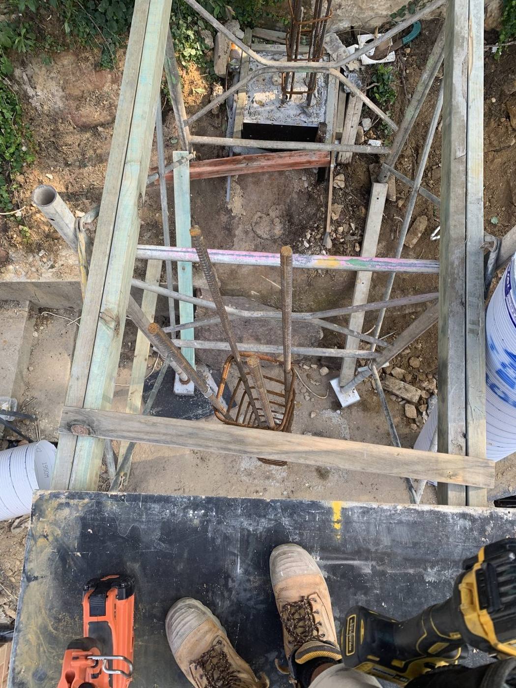 Deep pier footing excavation with reinforcement cage on a steep site by Loel Homes