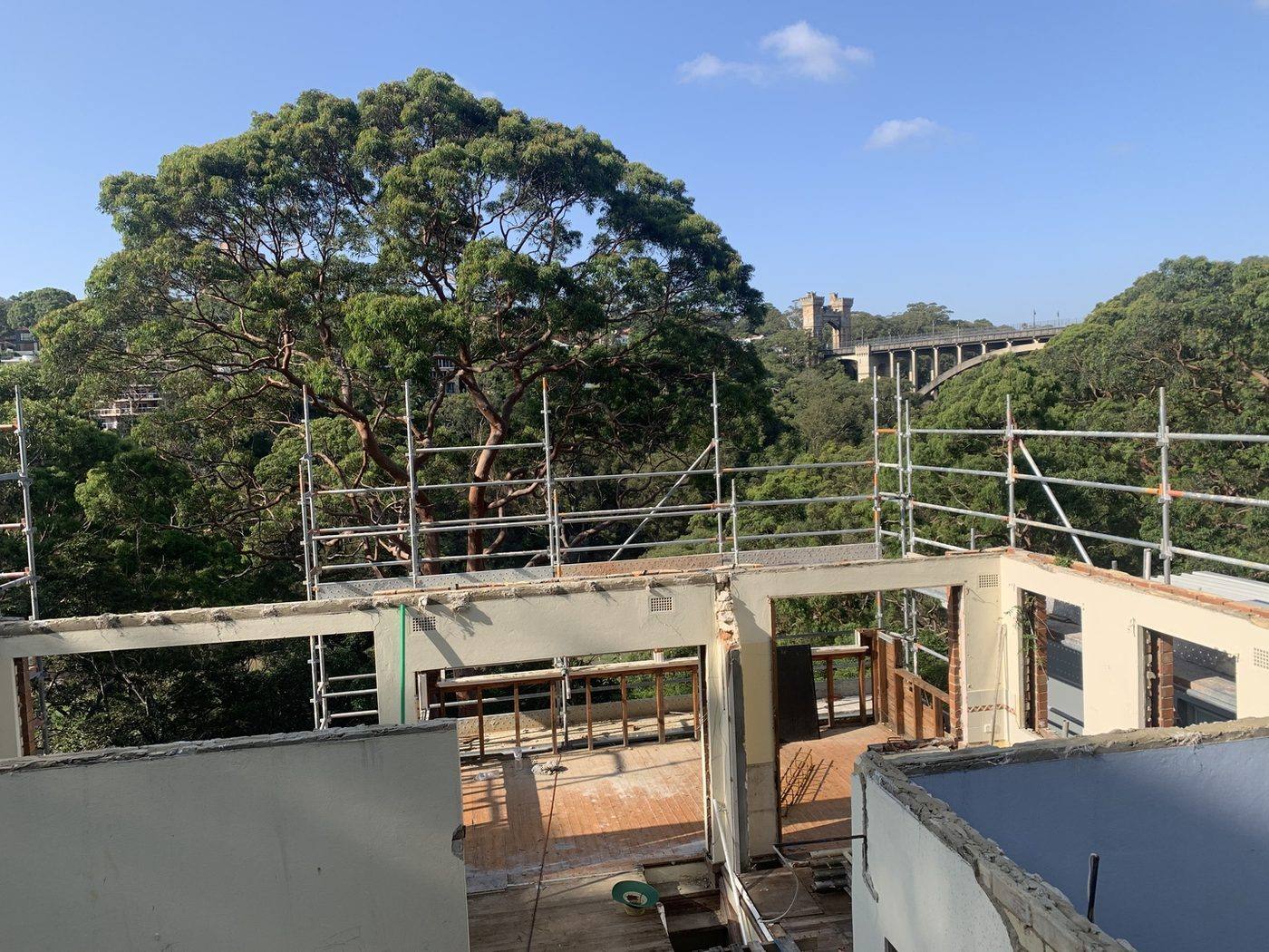 Structure stripped to walls with the Northbridge suspension bridge behind by Loel Homes