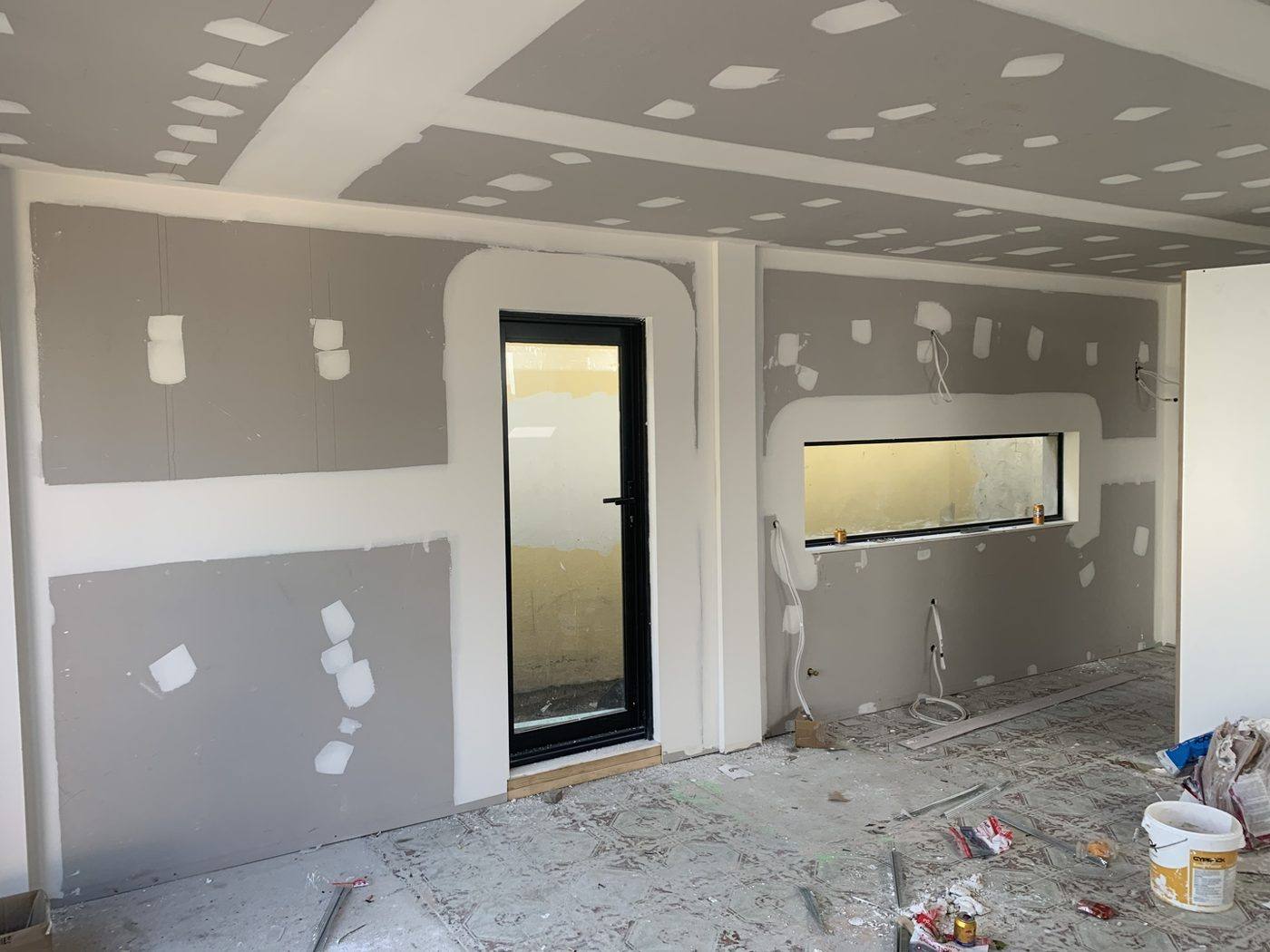 Interior plasterboard set with black-framed door and feature window, Dulwich Hill by Loel Homes