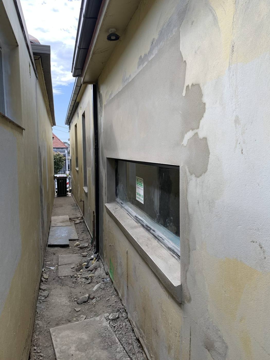 Cement render being applied with a new feature window, Dulwich Hill by Loel Homes