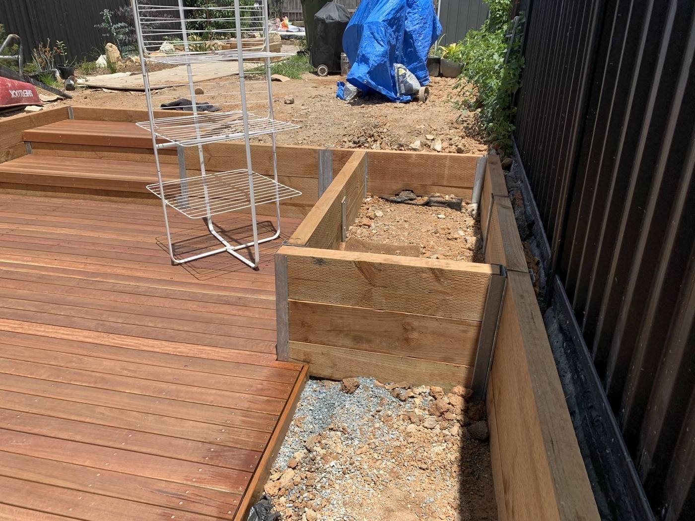Finished hardwood deck with hardwood-sleeper retaining garden beds along the boundary, Dulwich Hill by Loel Homes