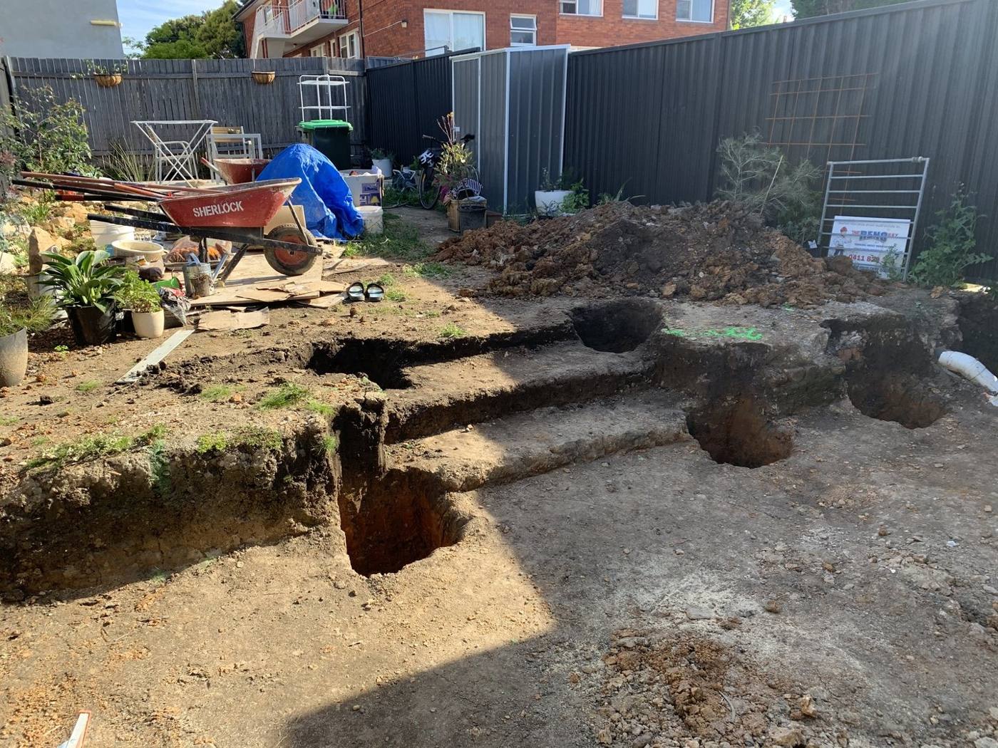 Rear yard during landscaping earthworks with soil graded and levelled behind the new extension, Dulwich Hill by Loel Homes