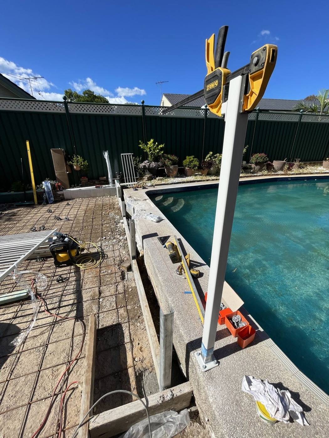 New timber deck being built alongside a pool during a surround upgrade by Loel Homes