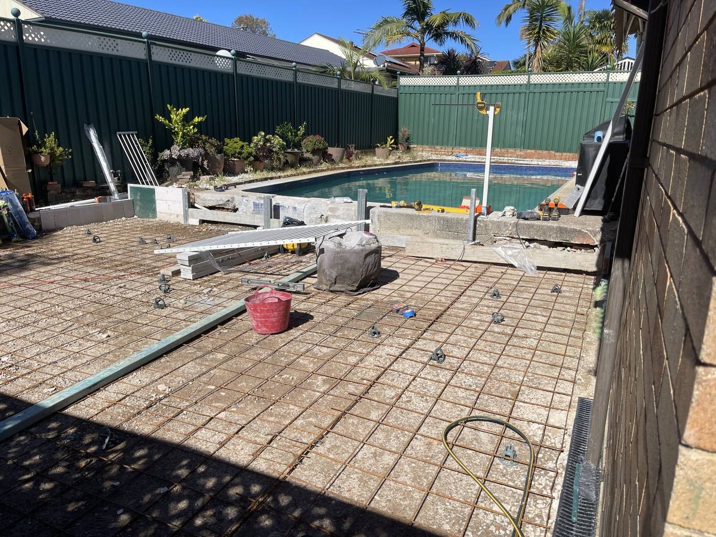 New pavers being relaid around a renovated pool surround by Loel Homes