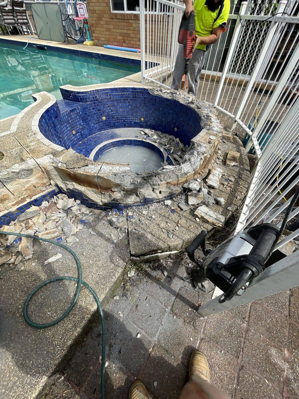 Old raised mosaic spa being demolished and broken out during a pool surround renovation by Loel Homes