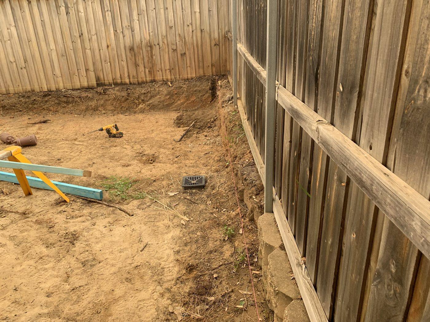 Cleared backyard with string lines set out ready for a pool build by Loel Homes
