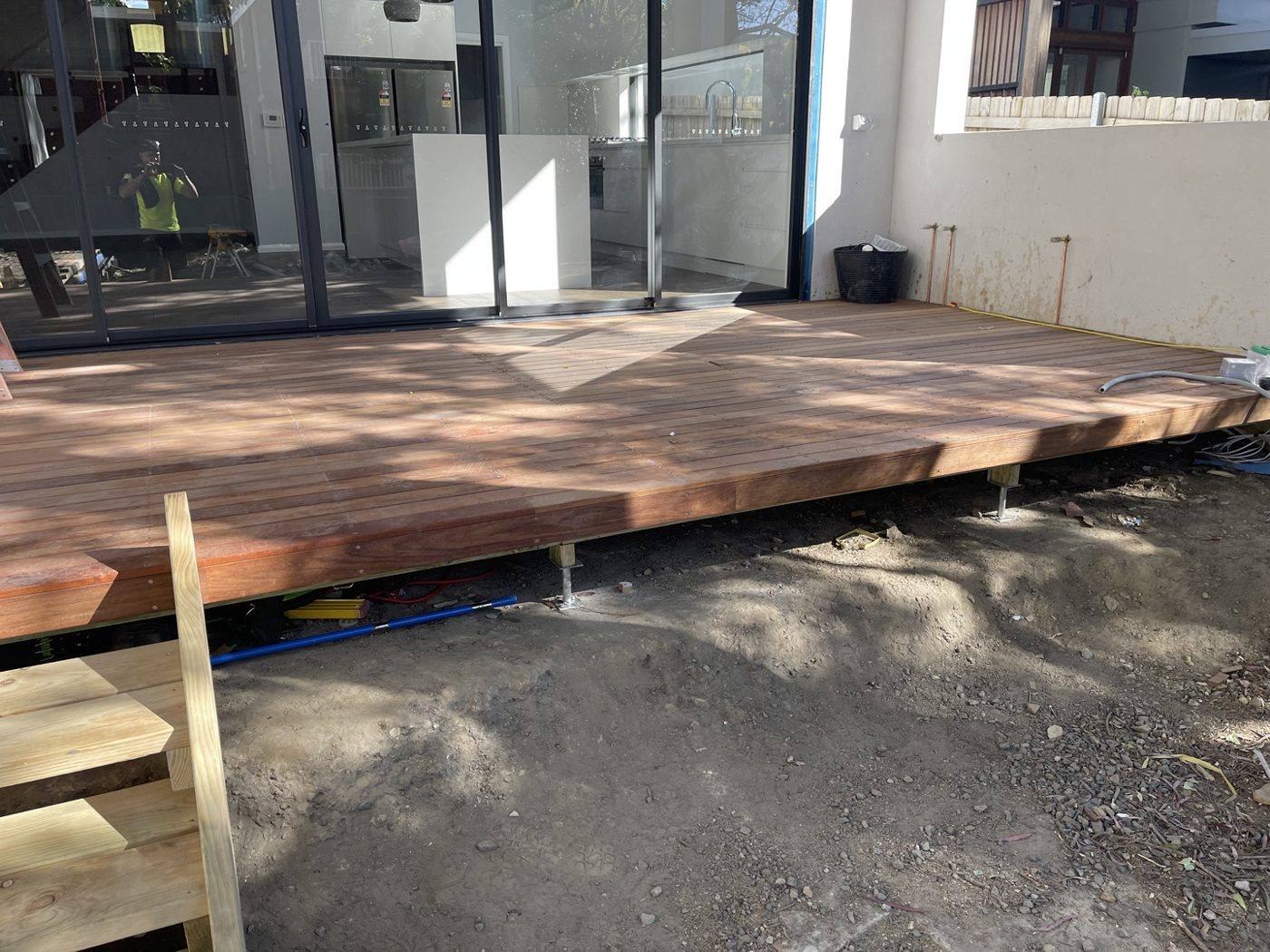 Low-line hardwood deck mostly boarded running along the rear of the home by Loel Homes