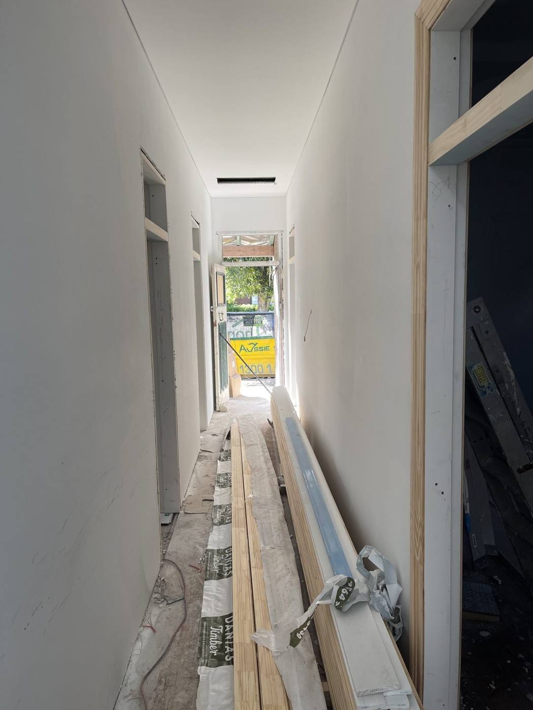 Plastered and set hallway with new skirting stacked ready to install, heritage terrace fit-out by Loel Homes