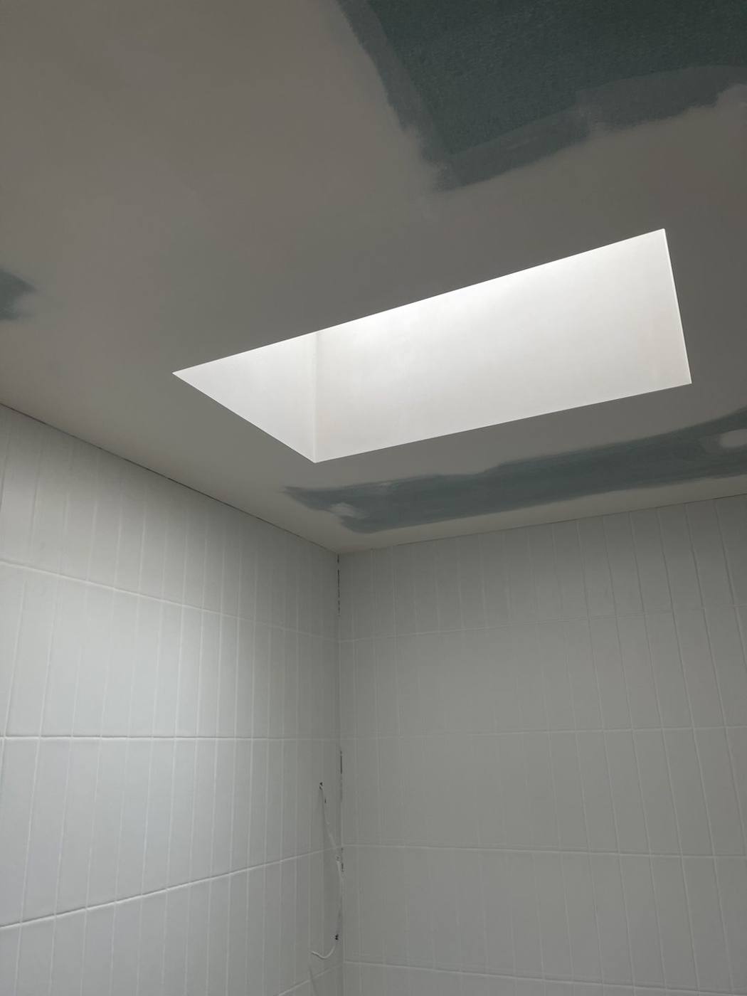 Lined skylight shaft bringing daylight into a tiled room, heritage terrace by Loel Homes