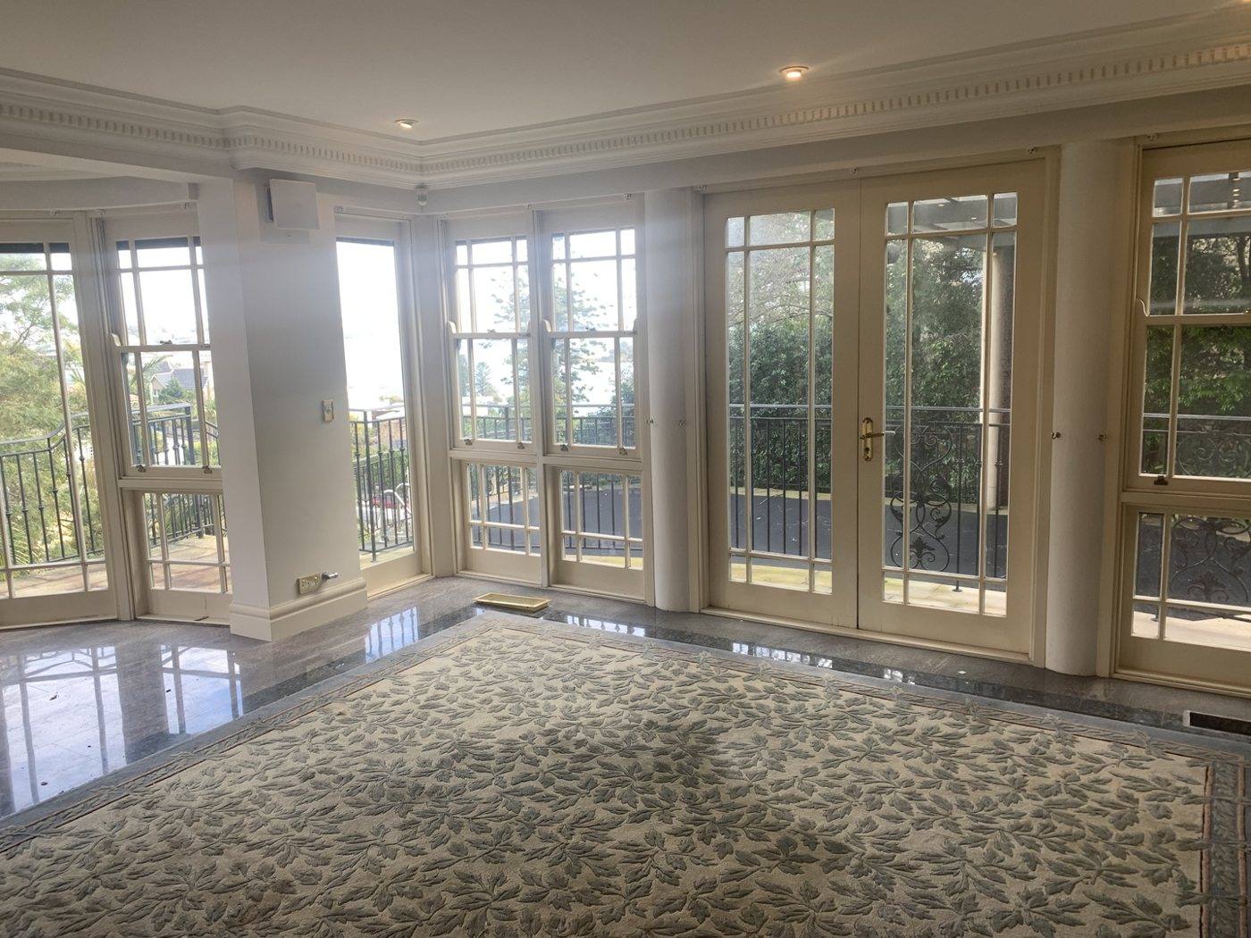 Living room with a wall of French doors to the balcony, Vaucluse by Loel Homes