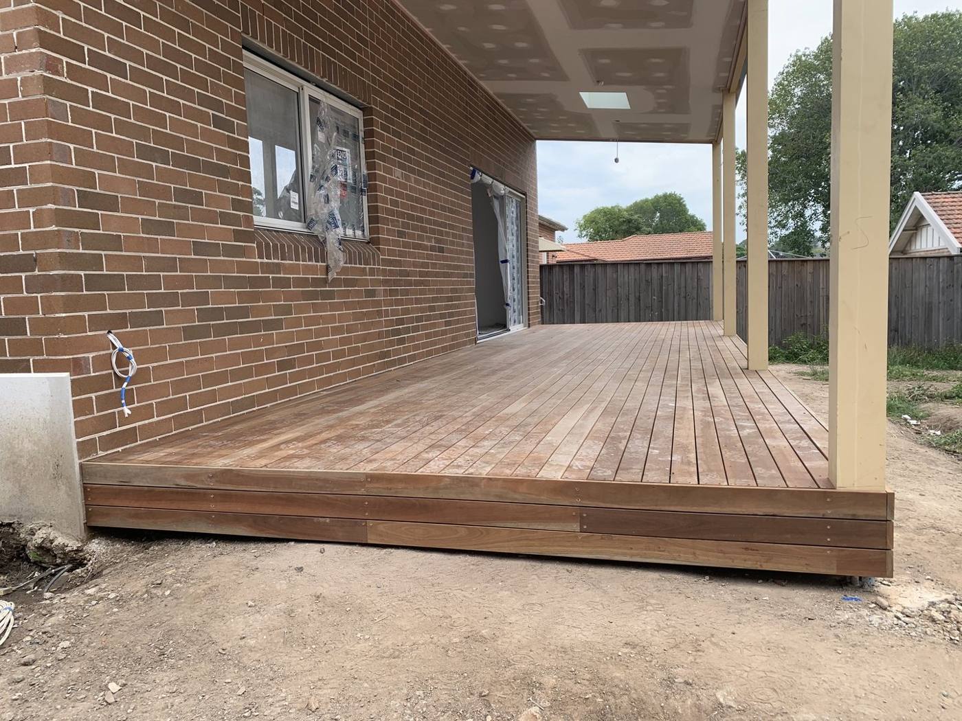 Deck boards laid under the new covered patio structure by Loel Homes